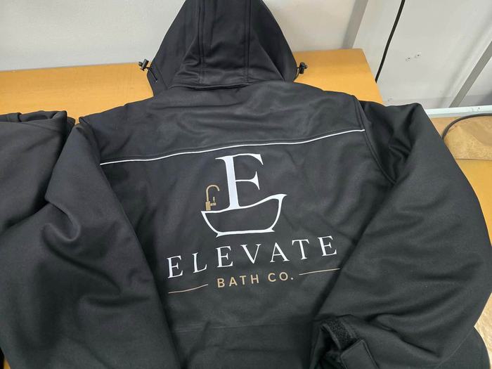 Elevate Bath Co. logo embroidered on a team jacket